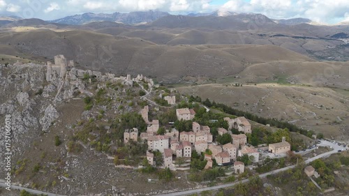 Drone aerial view of Monte Calascio, Abruzzo, featuring the medieval Rocca fortress and spectacular surrounding mountain landscapes