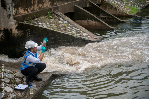 Wastewater treatment worker is collecting samples of water from a public well