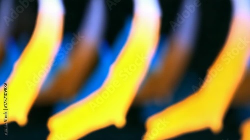 Abstract blurred motion of vibrant yellow and orange light. Close-up of flickering flames or energy waves. Dynamic colorful background with a soft focus bokeh effect