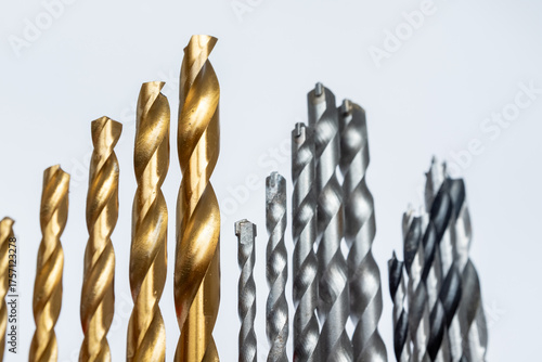 drill clamped in electric screwdriver rotates, close up. Step conical drill bit for drilling holes with different diameters on the wooden