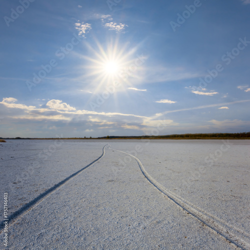 dry cracked saline land under a sparkle sun
