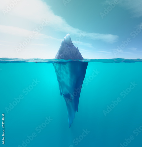 Huge iceberg emerging from azure waters under a clear sky near polar regions during the calm midday sun