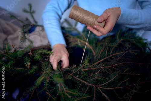 a family makes a wreath of pine needles, a Christmas tree for home decoration for Christmas