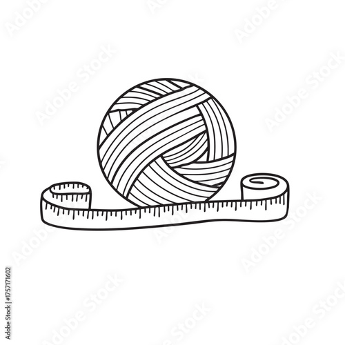 A skein of yarn beside a ruler and measuring tape