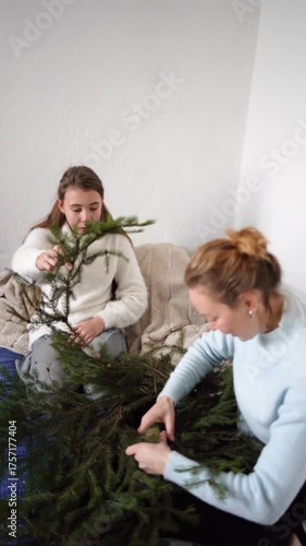 family makes a wreath of pine needles, a Christmas tree for home decoration for Christmas