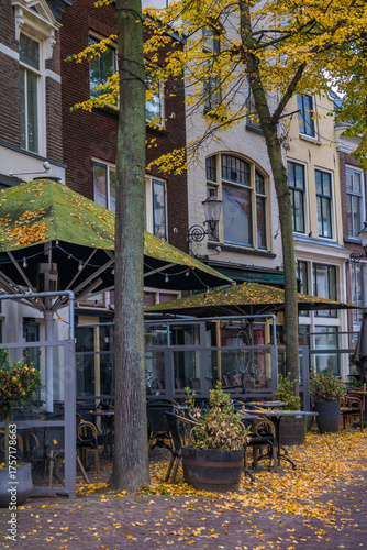 table and chairs of a street cafe in autumn leaves. High quality photo