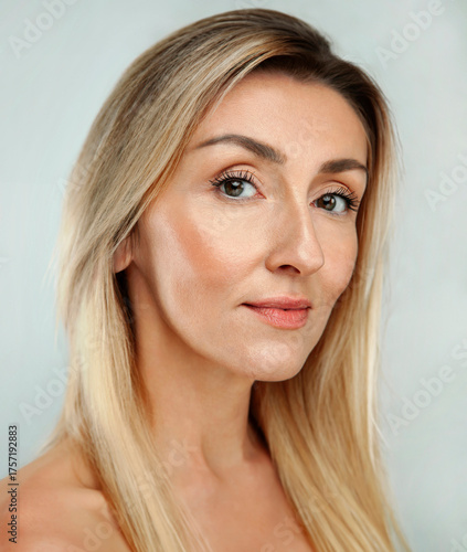 Gorgeous 50s mid middle aged mature blonde woman isolated on white background. Healthy face skin care beauty. Old lady close up smile radiant portrait. Anti age concept for Skincare, Cosmetics Product