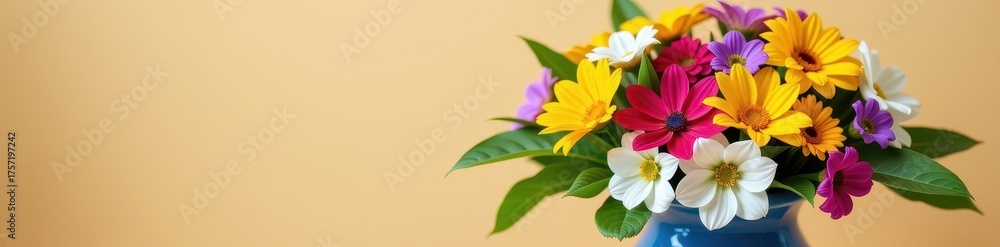Fototapeta premium A vibrant bouquet of assorted flowers and lush green leaves arranged in a classic blue ceramic vase, studio shot, leaves, green, arrangement