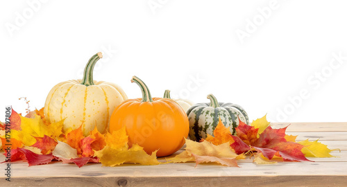Autumn harvest scene with pumpkins and colorful fall foliage on a wooden surface