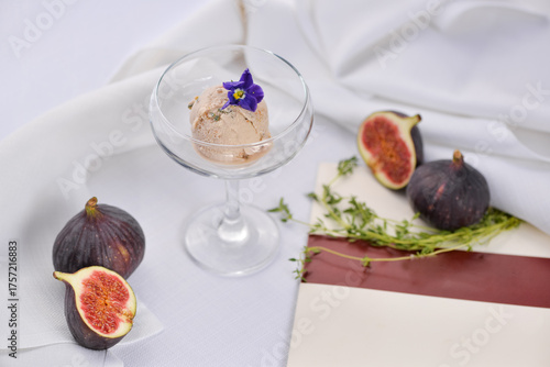 ice cream with figs in a glass on a light background with food decor