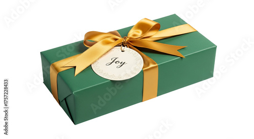 Green gift is wrapped with gold ribbon and 'Joy' tag resting on surface. - high quality Green gift is wrapped with gold ribbon and 'Joy' tag resting o
