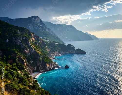 A scenic coastal landscape depicts a rugged mountain range meeting the turquoise sea under a partly cloudy sky