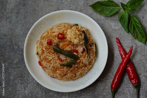 Thai basil fried rice with chicken and veggies served in a bowl, selective focus