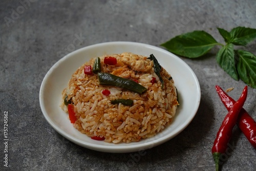 Thai basil fried rice with chicken and veggies served in a bowl, selective focus