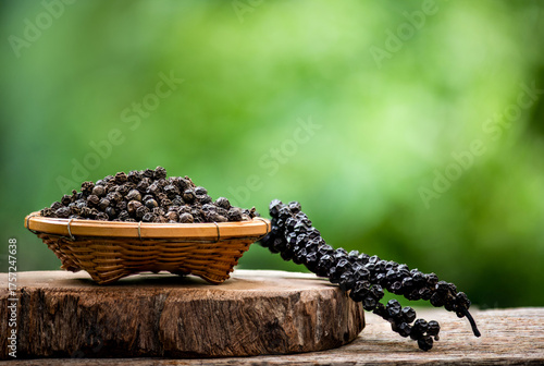 Dried black pepper and seeds on natural background.