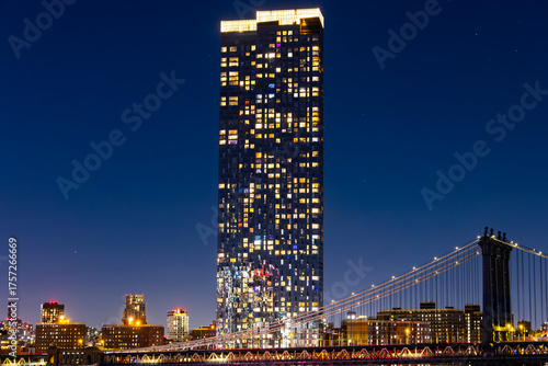 View of Manhattan Bridge at night with skyscraper and Manhattan.