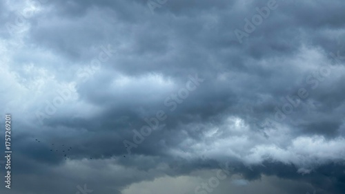 Fototapeta Naklejka Na Ścianę i Meble -  Moody storm clouds swallowed the horizon, whispering tales of Tempest Day, nature's chiaroscuro drama unfurling its wingspan