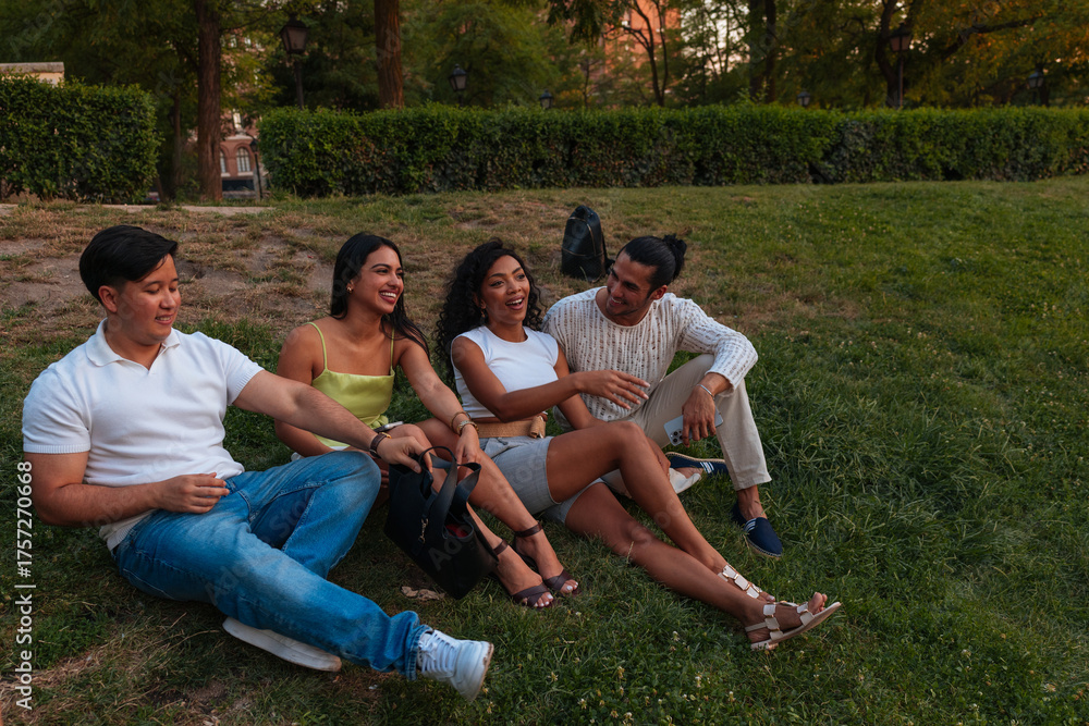 Fototapeta premium Group Of Friends Relaxing In A Park, Laughing And Chatting On A Sunny Day