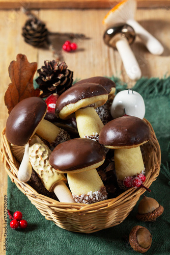 Mushroom and fir-shaped cookies made from shortcrust pastry and ceramic mushrooms on a wooden background.