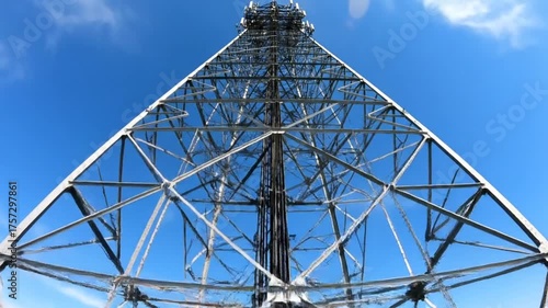 Tower structure against blue sky aerial view of communications mast
