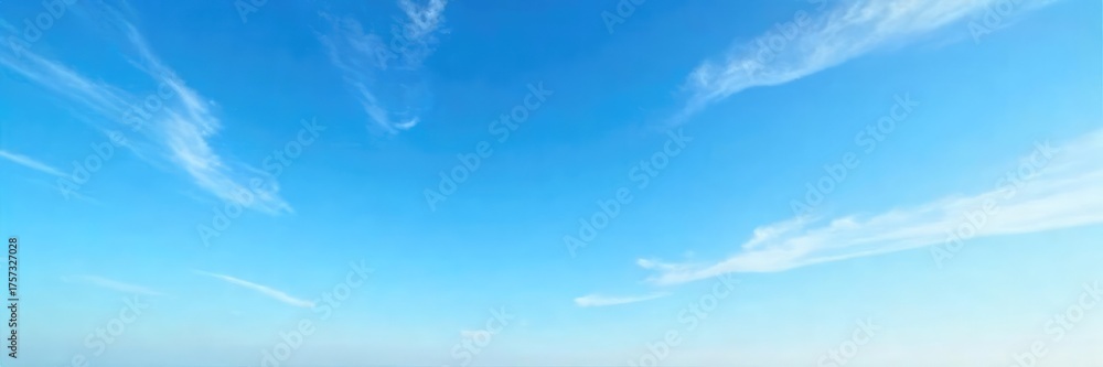 Fototapeta premium Vast expanse of a clear blue sky subtly veiled by wispy, high-altitude cirrus clouds, creating a serene and ethereal atmosphere Perfect for travel, weather, or nature-themed projects , scenic, day