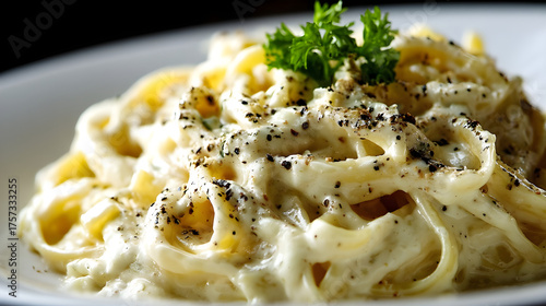 White plate serving delicious spaghetti carbonara with black pepper