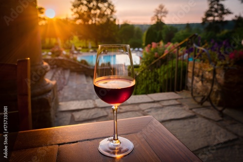 A Romantic Evening with a Glass of Red Wine as the Sun Sets Over a Picturesque Landscape