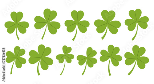 A group of green shamrocks are arranged in two rows on a white surface, representing St. Patrick's.