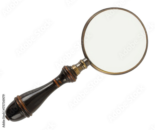 Vintage magnifying glass with an ornate dark handle isolated.