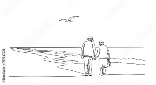 Elderly couple walking hand in hand along the beach at sunset  