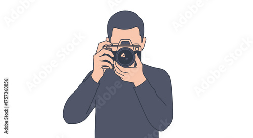 Man in dark sweater holding vintage camera up to his face, taking photograph