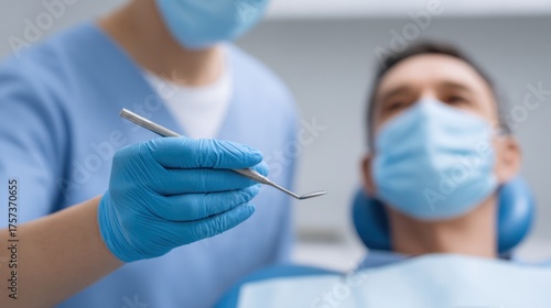 Dental Professional Preparing Tools for Patient Treatment in Modern Clinic Setting with Protective Gear