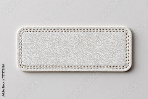 Blank White Rectangular Label with Stitched Border Edges for Text Space. Pristine fabric clothing label with tightly woven textile texture. Leather Jeans label mockup. Clear adherent tag. Empty oblong
