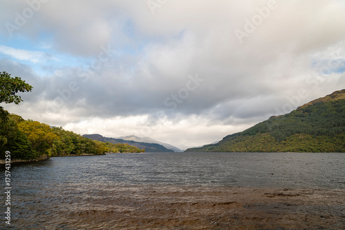Tableau sur toile A cloudy, autumnal HDR image of Loch Lomond looking north taken from Firkin Point picnic site near Inverbeg, Scotland
