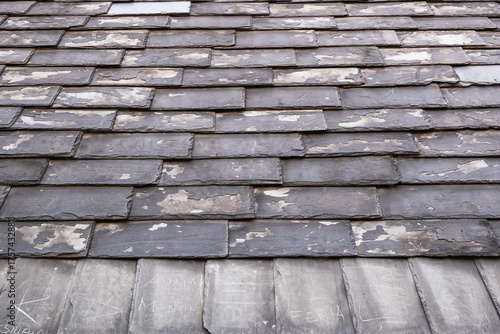 Weathered slate roof with paint peeling, rustic charm and history