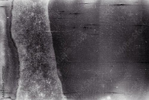Blank grained film strip texture background with heavy grain, dust and light leak. Old expired moldy photographic film scan.