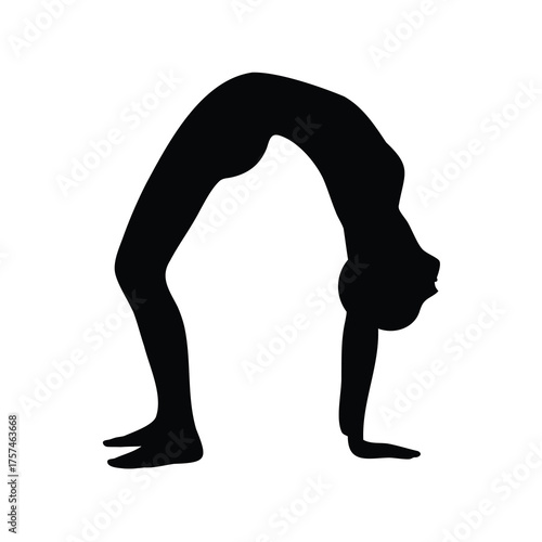 Silhouette of a woman in a Wheel Pose, a back bending yoga posture