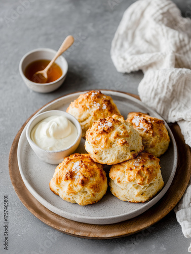 Plate of scones with butter and honey