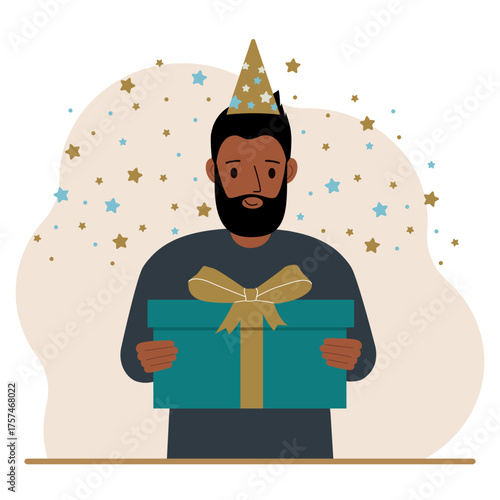 A man with a festive cap holds a large gift box with a bow.