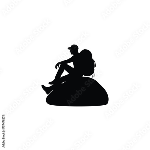 Hiker resting on a rock silhouette
