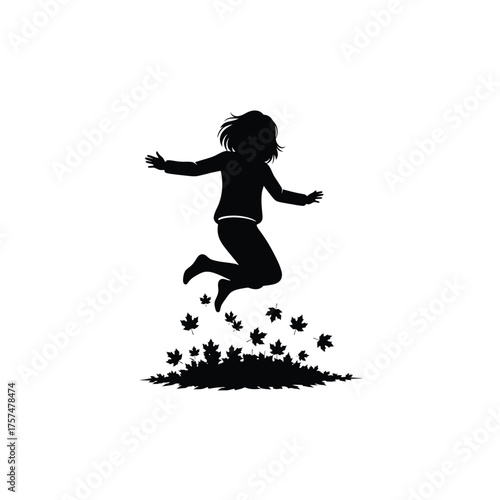 Joyful child jumping in autumn leaves silhouette