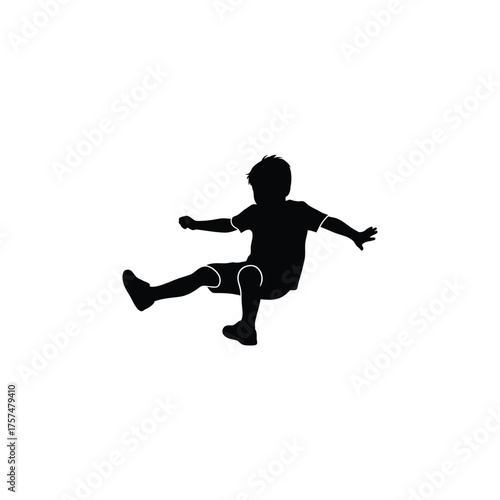 Young boy kicking a ball silhouette