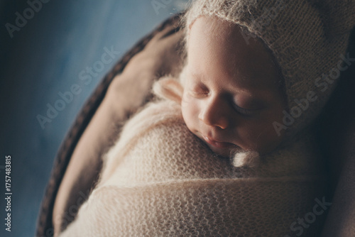 A newborn baby is wrapped in diapers with a wool cap in a basket. Swaddling, maternity hospital, family, ivf, life planning, parenting. A mother's love for her child. Baby food. High quality photo