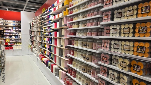 Brightly lit aisle of a store filled with various craft supplies and decorating items