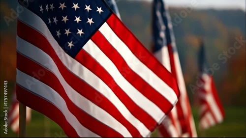 A Row of American Flags Gently Waving in Warm Autumn Sunlight on a Grassy Hillside