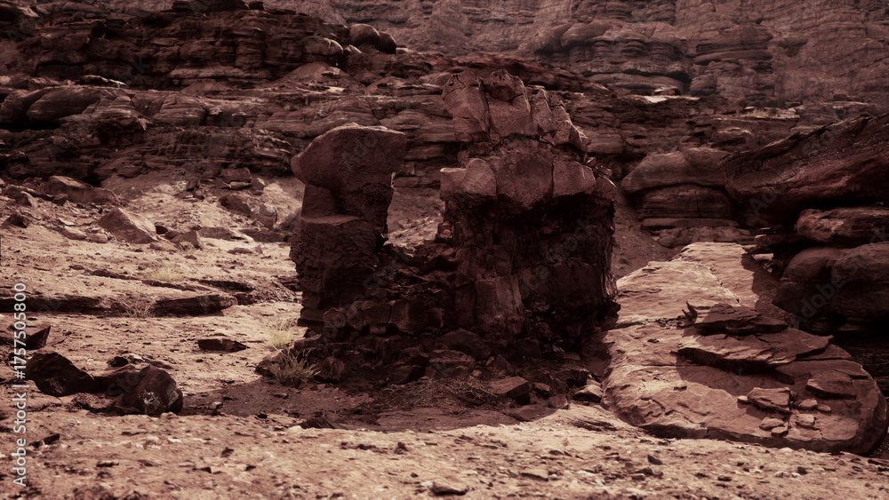 Obraz premium In the fading light of dusk, a striking rock formation rises from the sandy ground in a vast desert. Surrounding cliffs loom overhead, creating a sense of ancient mystery and isolation.