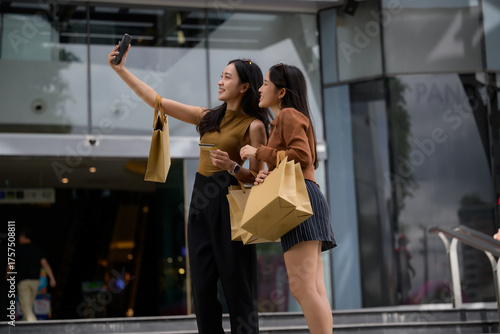 Friends shopping on city street taking selfie