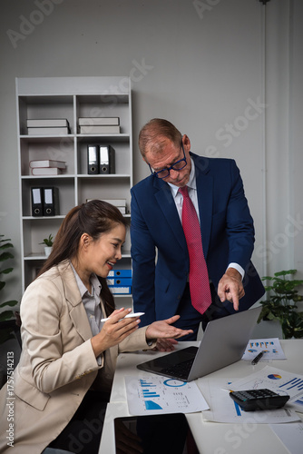 Business colleagues collaborating on analysis in office meeting