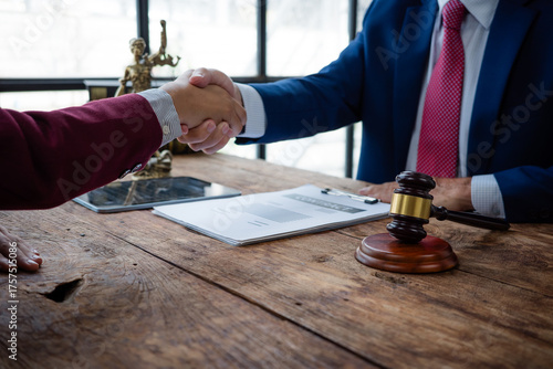 Lawyer and client shaking hands after legal agreement