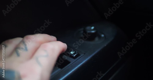 Close-up of a hand unlocking a car door using the power lock switch. Modern vehicle interior, security, safety features, convenience, and daily automotive routines.